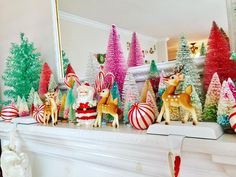 christmas decorations are displayed on a mantel