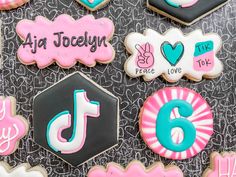 decorated cookies are arranged in the shape of letters and numbers on a black tablecloth