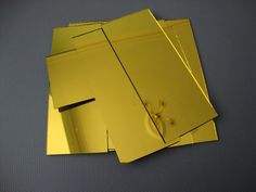 several pieces of shiny gold paper on top of each other