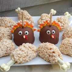 chocolate covered donuts decorated to look like turkeys with candy sticks sticking out of them