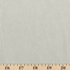 a ruler that is next to a piece of fabric with small dots on the side