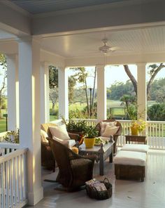 the porch is covered with wicker furniture