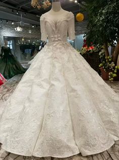 a white wedding dress on display in a store