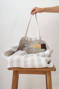 "This large linen beach bag is perfect for a long-awaited vacation, picnic, or trip to the beach. Beautifully made of soft heavyweight linen, with an extra linen lining inside. The bag is roomy enough to carry large towels along with other essentials. Linen is environmentally friendly, durable, and looks better and better with age. Color: white/natural stripes Bag size: Height: 35 cm / 14\" Length: 45 cm / 18\" Width: 22 cm / 9\" Handles: 26 cm / 10\" (Strap drop length) *Custom size available. Oversized Beach Bags, Creative Tote Bag, Perfect Beach Bag, Bag With Pockets, Tote Bags Sewing, Oversized Tote Bag, Striped Bags, Oversized Tote, White Beach