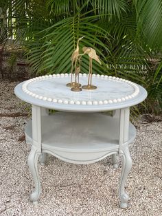 a white table with two birds on it