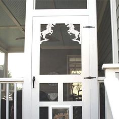 an image of a white door with horse cutouts on the glass and side panels