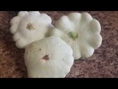 three white flowers sitting on top of a counter