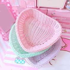 three wicker baskets stacked on top of each other in front of a hello kitty dresser