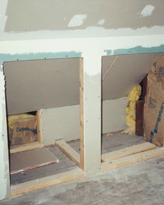 two boxes are sitting in the corner of a room with unfinished walls and flooring