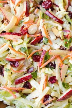 a salad with apples, cranberries and lettuce is shown in this video