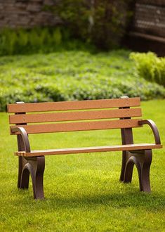 a wooden bench sitting on top of a lush green field