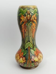 the vase is decorated with flowers and leaves