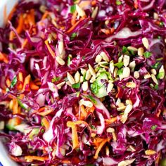 a bowl filled with red cabbage and nuts