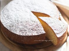 a cake that has been cut into pieces and is sitting on a wooden platter