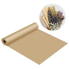 a roll of brown paper next to a bunch of lavenders on a white background