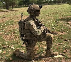 a soldier sitting in the middle of a field