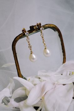 The Audrey pearl and crystal bridal earrings make a refined finishing touch to a timeless bridal ensemble. Light and delicate, these earrings are designed to softly move and sway. Inspired by the grace and femininity of the classic bride, the Audrey earrings feature softly shimmering crystals and lustrous freshwater pearls. Understated glamour at its best. DETAILS * Length: 3.5cm * Freshwater pearls, cubic zirconia accents. * 14k gold filled. * Handmade to order. * PRODUCTION Made for you. Your Audrey pearl earrings will be ready to ship within 3-5 weeks of purchase. RUSH A rush order is available for an additional fee. Please contact us for details. POLICIES Please read our policies before making your purchase: www.etsy.com/shop/NoonOnTheMoon/policy PHOTO CREDITS Model photography by Lisa Bridal Pearl Earrings, Drop Pearl Earrings, Pearl Earrings Gold, Understated Glamour, Classic Bride, Crystal Bridal Earrings, Classic Brides, Bridal Earrings Pearl, Wedding Jewelry Earrings