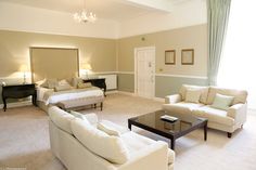 a living room filled with furniture and a chandelier