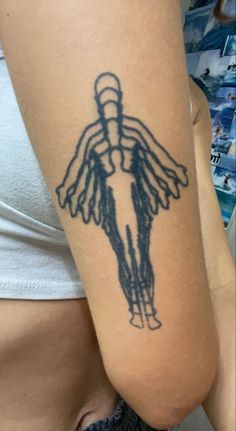 a woman's arm with a tattoo on it that has an image of a person holding