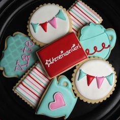 decorated cookies are arranged on a black plate