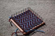 a weaving project is laying on the floor