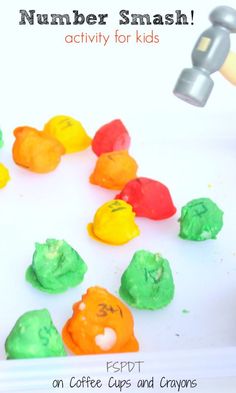 a child is playing with colorful gummy bears and making them look like they are eating