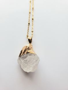 This cool rough quartz necklace makes a great treat for yourself or a gift for someone special. The quartz nugget is approximately 1"x1" The quartz is dipped in a gold color iron brass. Quartz is said to ♥ Cleanse ♥ Promote Clarity ♥ Protect ♥ Connect ♥ Enhance Wisdom ♥ Elevate Creativity Golden 304 Stainless Steel Satellite Cable Chain with Lobster Claw Clasp Gold Crystal Necklace With Raw Stone As Gift, Gold Crystal Necklace With Raw Stone For Gifts, Adjustable Gold Crystal Necklace, Adjustable Gold Mineral Crystal Necklace, Gold Necklace With Raw Stone, Bohemian Raw Stone Necklace For Gift, Spiritual Gold Necklace With Raw Stone, Bohemian Raw Stone Crystal Necklace For Healing, Bohemian Necklace With Raw Mineral Crystal Stone