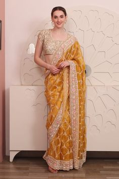 Yellow organza saree with floral, thread and sequins hand embroidery. Comes with a padded blouse. - Aza Fashions Chanderi Pre-draped Saree With Zari Work For Reception, Silk Pre-draped Saree With Zari Work For Reception, Designer Organza Pre-draped Saree With Dori Work, Embroidered Chanderi Pre-draped Saree For Reception, Yellow Embroidered Pre-draped Saree For Reception, Festive Organza Pre-draped Saree With Pallu, Yellow Organza Pre-draped Saree For Eid, Gold Fitted Organza Pre-draped Saree, Traditional Drape Choli With Dori Work In Organza