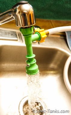 a faucet that is connected to a sink with water running from the faucet