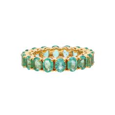 a gold ring with green stones on it