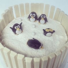 there is a cake with penguins on it