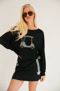 Rule the course in style with our GOLF QUEEN black long-sleeve sweater. Featuring a sparkling silver rhinestone Golf Cart patch and a chic silver cursive golf patch, this light weight sweater is perfect for both on and off the course. Show off your love of golf while looking effortlessly cool. All orders are currently shipping within 14 business days. To receive item quicker, expedited shipping is available at checkout. Golf Brand Sweater, Winter Golf Outfit, Black Tennis Skirt, Black Long Sleeve Sweater, Queen Black, Clubbing Aesthetic, Athletic Skirt, Golf Sweaters, Golf Attire