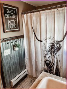 a bathroom with a cow shower curtain next to a sink and bathtub in it