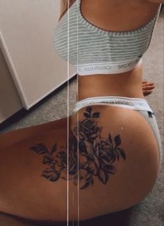 a woman's back with flowers on it and the bottom half of her stomach