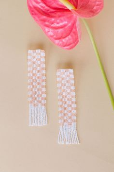 This Mary is all about how her garden grows. Our hand beaded checker print statement earrings with fringe detail on the bottom are perfect to be paired with our Evan hat, or a basic white t-shirt. available in peach plaid: our opaque peach with bright white - glass bead plaid statement earrings - made in Mexico - stainless steel post back - 4” length 1” width .75” tassels White Handwoven Earrings For Summer, Trendy Beige Jewelry For Spring, Handwoven Pink Jewelry For Summer, Summer Handwoven Pink Jewelry, Trendy Spring Jewelry With Fringe, Trendy Fringe Earrings For Summer, White Fringe Earrings For Summer, Checker Print, Steel Post