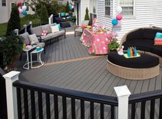 an outdoor deck with furniture and decorations on it