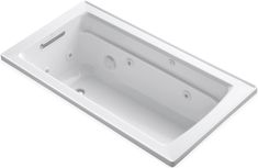 a white bath tub sitting on top of a white counter next to a wall mounted faucet