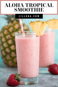 two glasses filled with pink smoothie next to pineapple