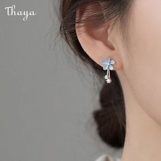 Step up your fashion game with Thaya's exquisite 925 Silver Flower Pattern Earrings, designed exclusively for women. These earrings feature an elegant floral design that adds a touch of sophistication to any outfit. Made with high-quality 925 silver, these earrings are built to last and are sure to become a staple in your accessory collection. The timeless flower pattern is perfect for multiple occasions and compliments a variety of styles. These earrings are the perfect addition to your jewelry box in 2022 and beyond. Shop now and elevate your fashion sense with Thaya. Flowers Earrings, Daisy Earrings, Earrings Studs, Earring Patterns, Flower Earrings Studs, Silver Flowers, Tassel Earrings, Flower Earrings, Pretty Flowers