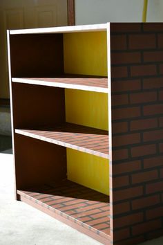 the shelves are made out of cardboard and have yellow paint on them, as well as red bricks