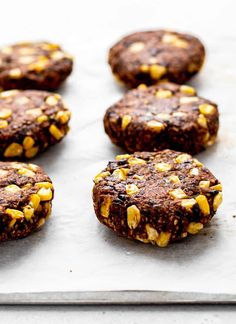 chocolate cookies with nuts are on a baking sheet