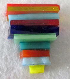 several different colored pieces of glass sitting on top of each other