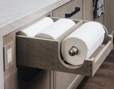 two rolls of toilet paper are in the drawer