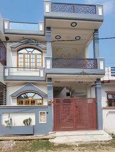 the front of a two story house with balconyes and balconies on each floor