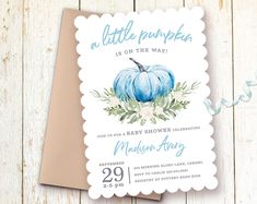 a little pumpkin is on the way baby shower party invitation with blue pumpkins and greenery