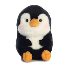 a black and white stuffed penguin sitting on the ground