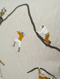 a close up of a piece of fabric with people on it and one person wearing skis