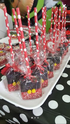 there are many candy bars wrapped in plastic wrappers on the table with red and white polka dots