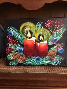 a painting of two candles with pine cones and berries