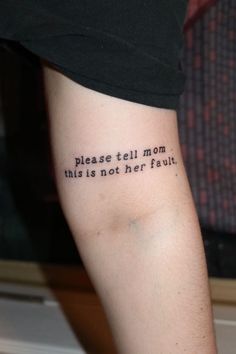 a person with a tattoo on their arm that says please tell mom this is not her fault